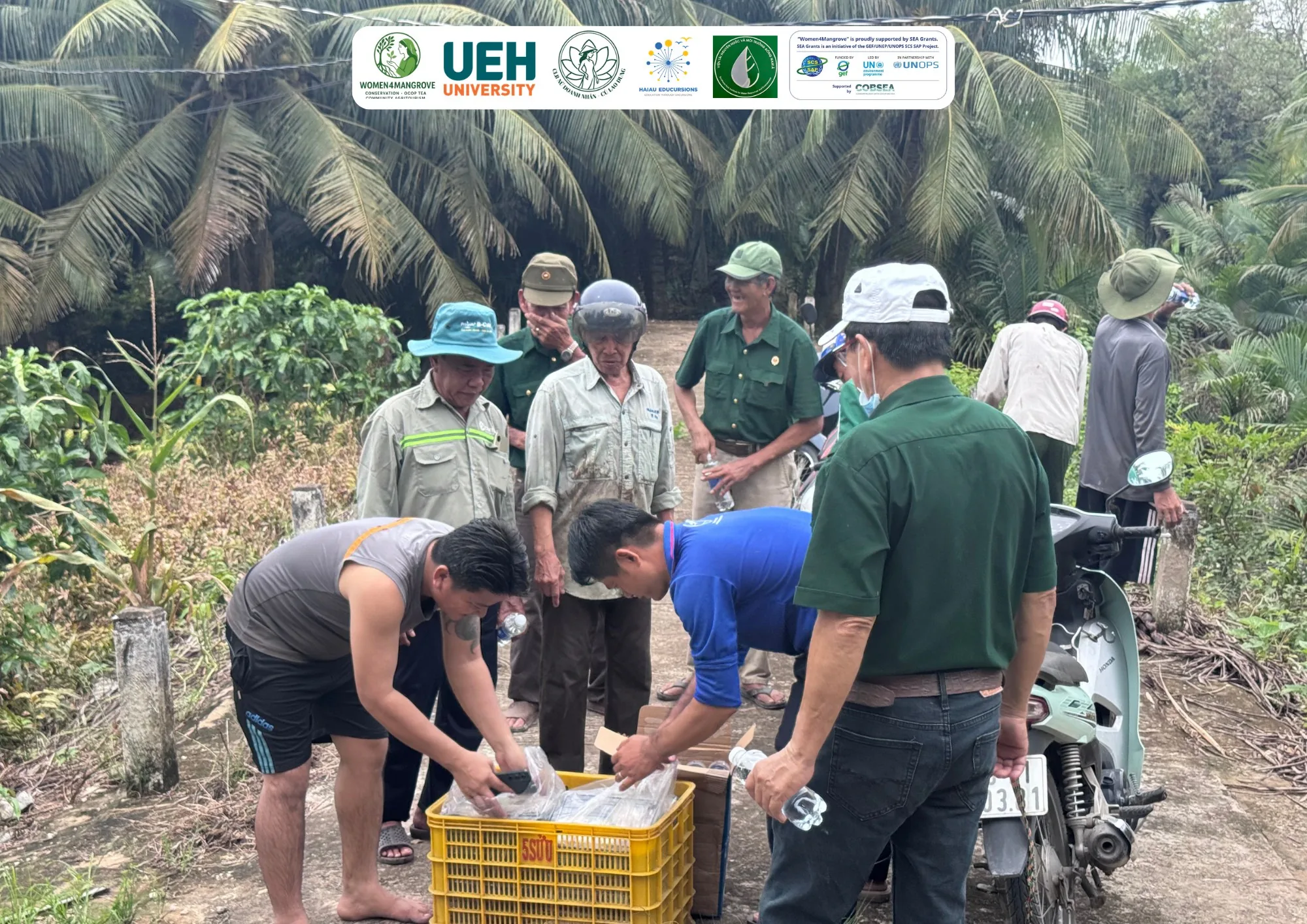 Women4Mangrove project team distributing supplies to local residents during the mangrove planting campaign